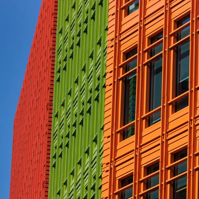 bright building facades next to a blue sky